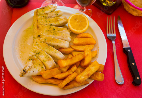 Fried squid served with baked potatoes. High quality photo