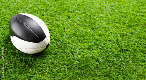 american football ball on a green grass