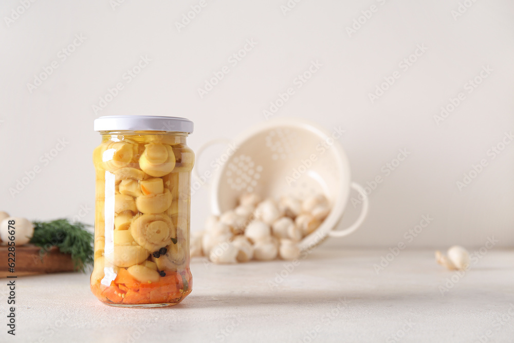 Jar with canned mushrooms on light background Jar with canned mushrooms on light background