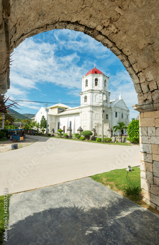 The Cuartel Ruins and Our Lady of Conception Church seen through an archway  Oslob Cebu Island The Philippines.