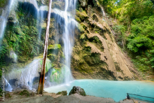 Visitors to Tumalog Water Falls  enjoy the azure bluewaters of the pool beneath.