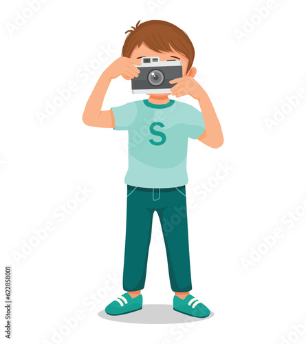 Little boy taking photo with camera 