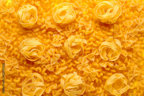 Raw fettuccine, farfale and cavatappi pasta as background, closeup © Pixel-Shot