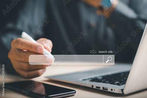 Fototapeta Naklejka Na Ścianę i Meble -  Man using a digital pen to point at an online job search bar, symbolizing the quest to find the perfect career opportunity amidst a sea of information and possibilities. job search