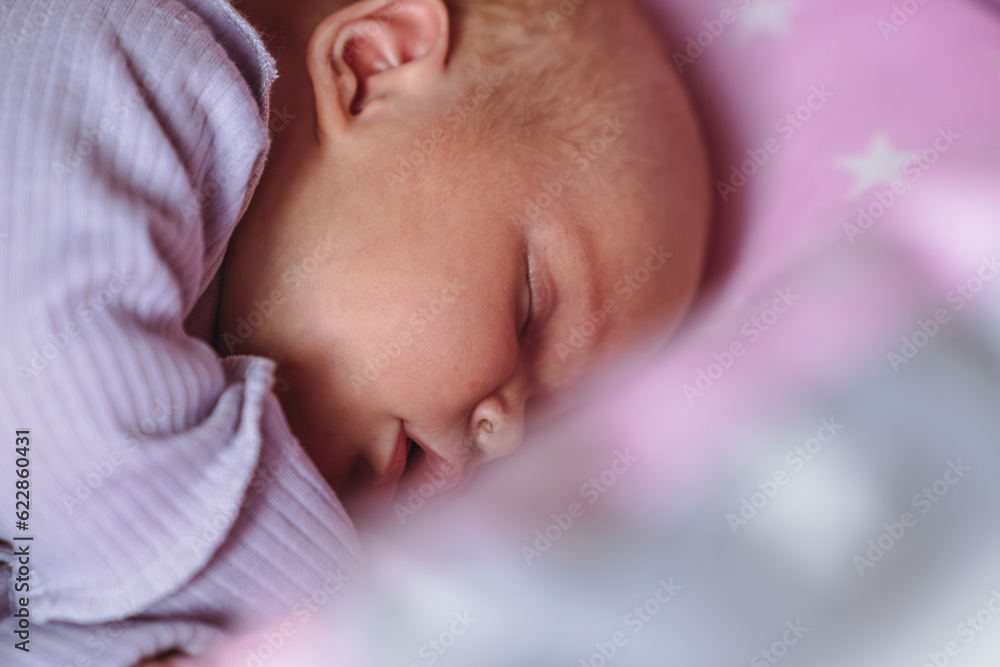Portrait of a charming newborn baby sleeping in a bed Portrait of a charming newborn baby sleeping in a bed
