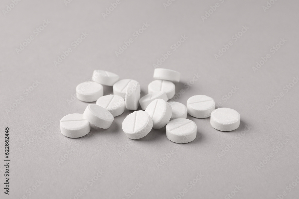 Pile of round pills on light grey background Pile of round pills on light grey background