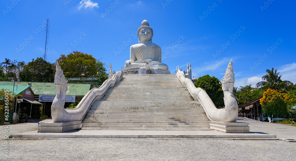 Stairs protected by Naga dragons leading up to the Great Buddha of Phuket aka Ming Mongkol Buddha, a seated Maravijaya Buddha statue covered in white Burmese marble tiles on Phuket island, Thailand