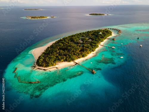 Aerial view of tropical island with water villa, Baa Atoll, Maldives. photo