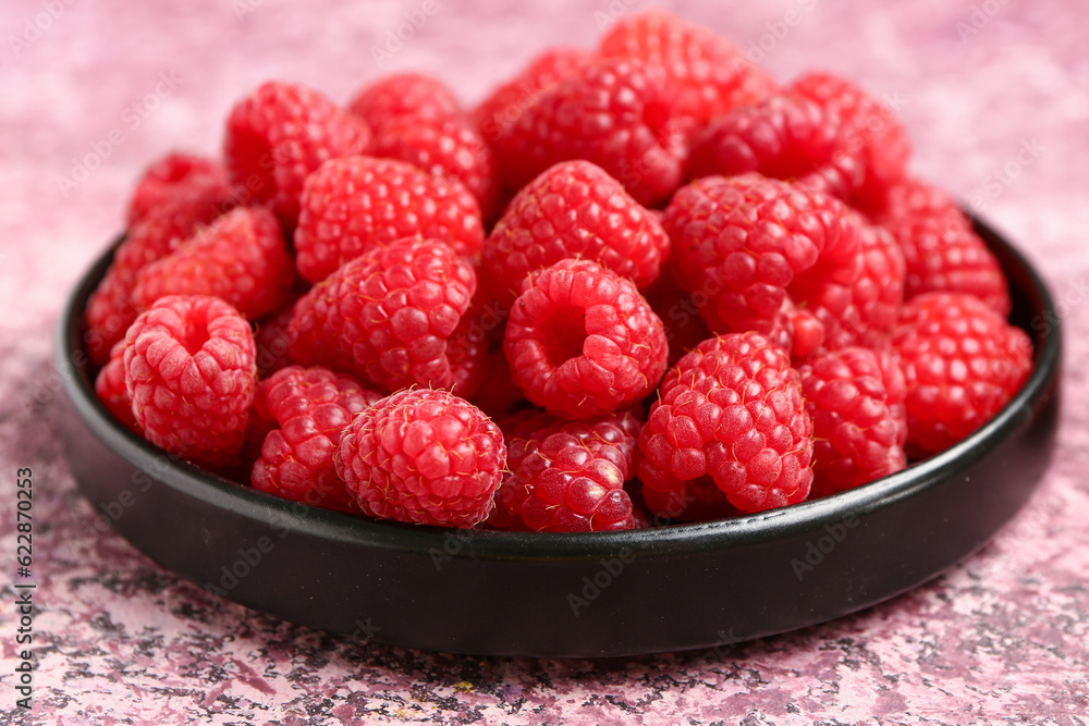 Tray with fresh raspberries on purple background Tray with fresh raspberries on purple background