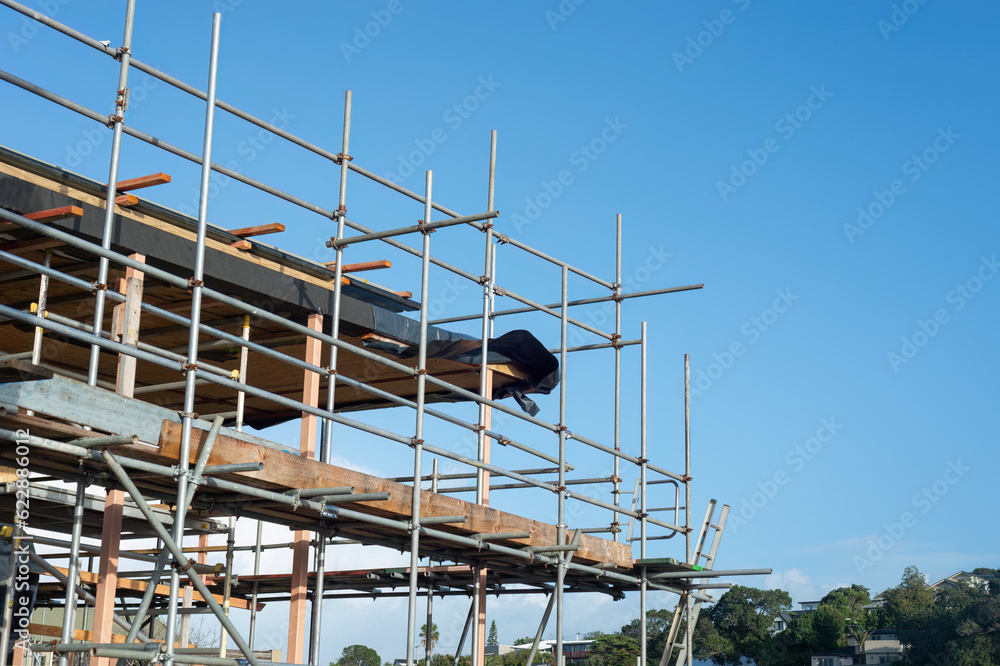 Residential house under construction with metal scaffolding around. Auckland.