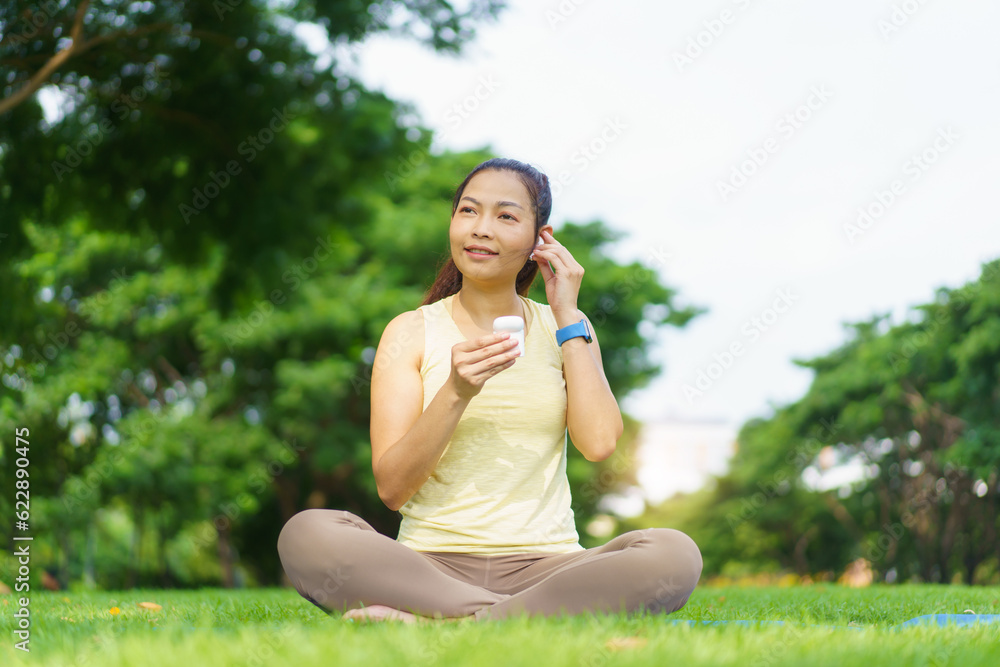 Beautiful smart and good looking Asian adult woman doing a yoga or body weight exercise and yoga at the park. Beautiful smart and good looking Asian adult woman doing a yoga or body weight exercise and yoga at the park.