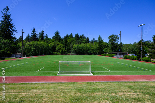 Artificial grass soccer and recreational sports field on a sunny summer day 