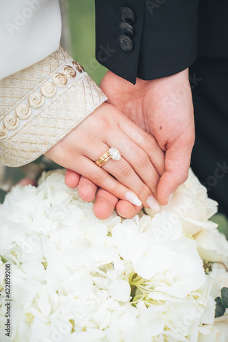 Close Up of Bride in Groom Hands with Wedding Rings and White Flowers – Muslim Wedding, Marriage Ceremony, Love, Romance, Commitment, Engagement, Bridal Jewelry, Islamic Culture, Marriage