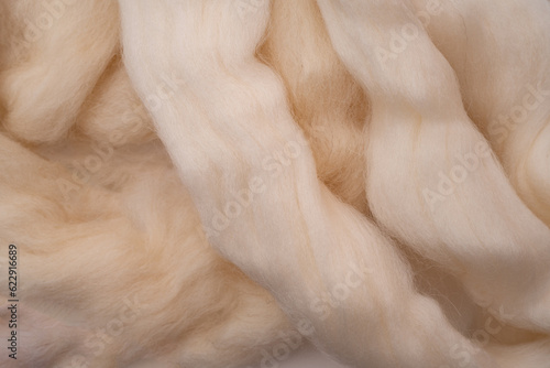 White merino wool for felting as background.