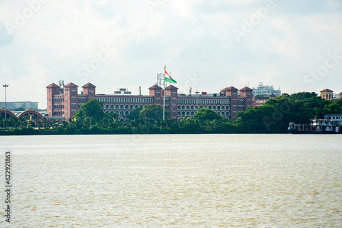 Canvas Print 8th July, 2023, Kolkata, West Bengal, India: The famous Howrah Railway station on the bank of river Hooghly photo taken from other bank of river