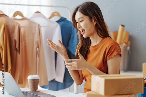 How To Start A Clothing Store Online Business apparel! Young confident asian female fashion owner social media influencer Live selling clothes, new products at home office small business e-commerce.