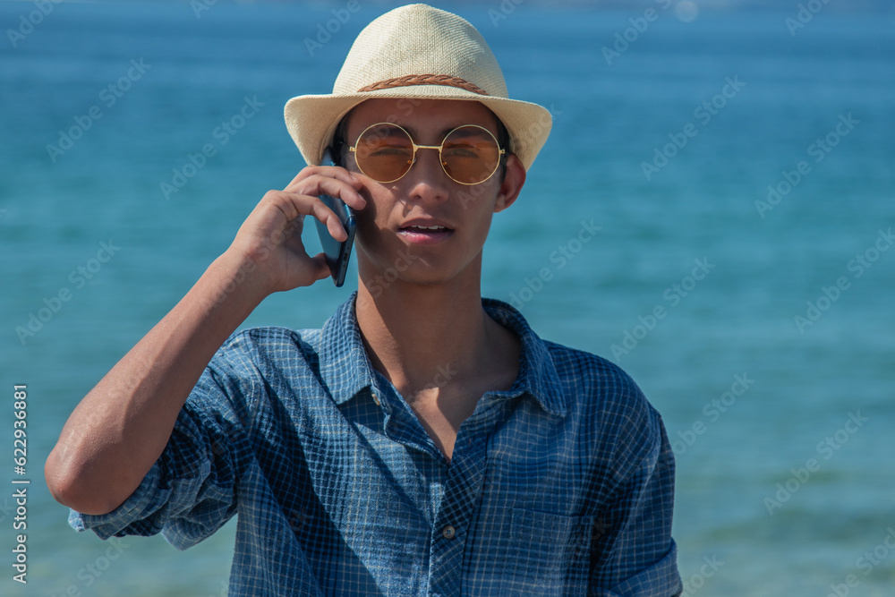 young man on the beach talking on the mobile phone