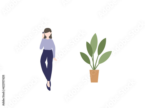 スマホで通話する女性と観葉植物