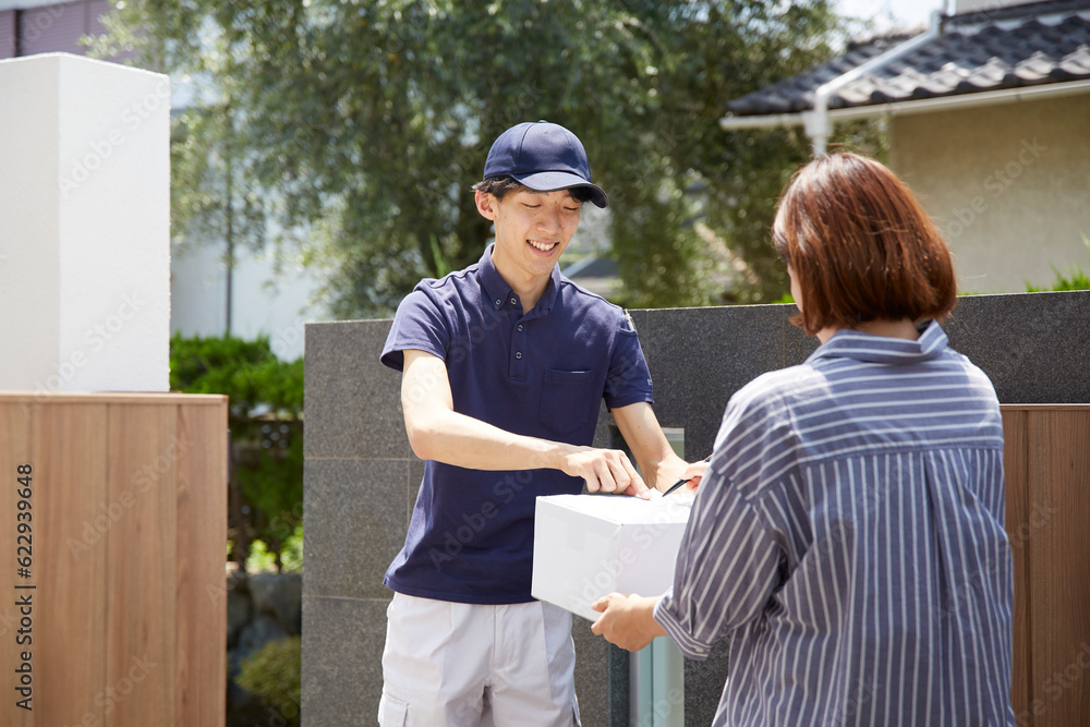 荷物の受け渡しをする宅配員 荷物の受け渡しをする宅配員