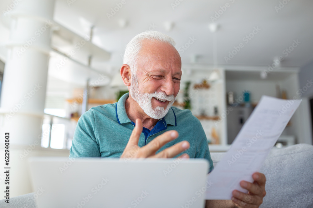Fototapeta premium surprised, laughing retired man joyfully examines a document, analyzing financial information. Expressing excitement, he may have received a tax refund or bank loan approval, capturing the success
