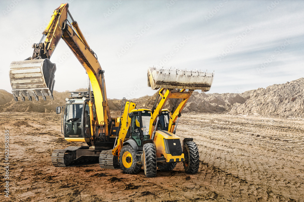 Modern construction machinery at a construction site in a quarry. Powerful modern equipment for earthworks. Rental of construction equipment. Excavator, dump truck, bulldozer, loader. Modern construction machinery at a construction site in a quarry. Powerful modern equipment for earthworks. Rental of construction equipment. Excavator, dump truck, bulldozer, loader.