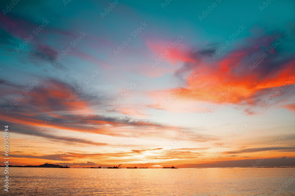Sunset Colorful sunset at the sea. Romantic Sunet go down, blue and orange clouds flow in sky. Majestic summer landscape. Beautiful sky fluffy clouds evening day