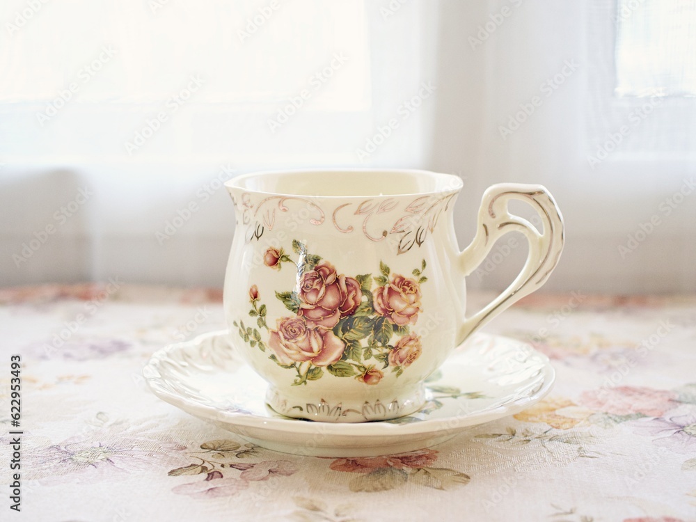 Antique cup of tea with saucer ,yellow orange rose flowers background ,porcelain vintage style ,old English coffee cup still life for wallpaper ,romance roses backgrounds Antique cup of tea with saucer ,yellow orange rose flowers background ,porcelain vintage style ,old English coffee cup still life for wallpaper ,romance roses backgrounds