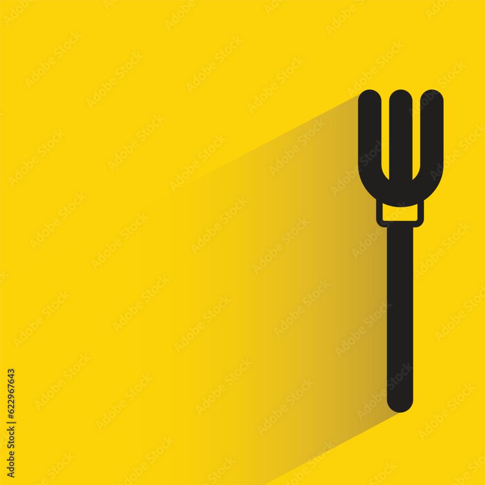 fork with shadow on yellow background fork with shadow on yellow background