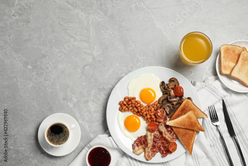 Traditional English breakfast served on grey marble table, flat lay. Space for text