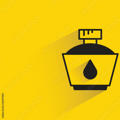 ink bottle with shadow on yellow background