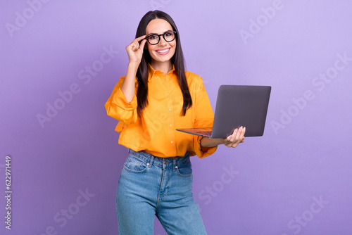Portrait of intelligent satisfied woman long hairstyle wear oversize shirt touch glasses hold laptop isolated on violet color background