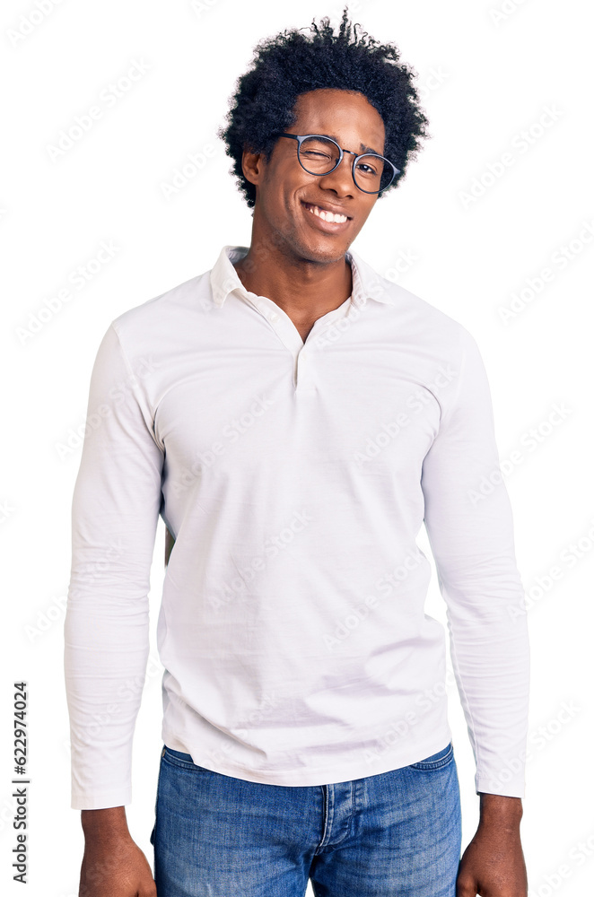Handsome african american man with afro hair wearing casual clothes and glasses winking looking at the camera with sexy expression, cheerful and happy face. Handsome african american man with afro hair wearing casual clothes and glasses winking looking at the camera with sexy expression, cheerful and happy face.