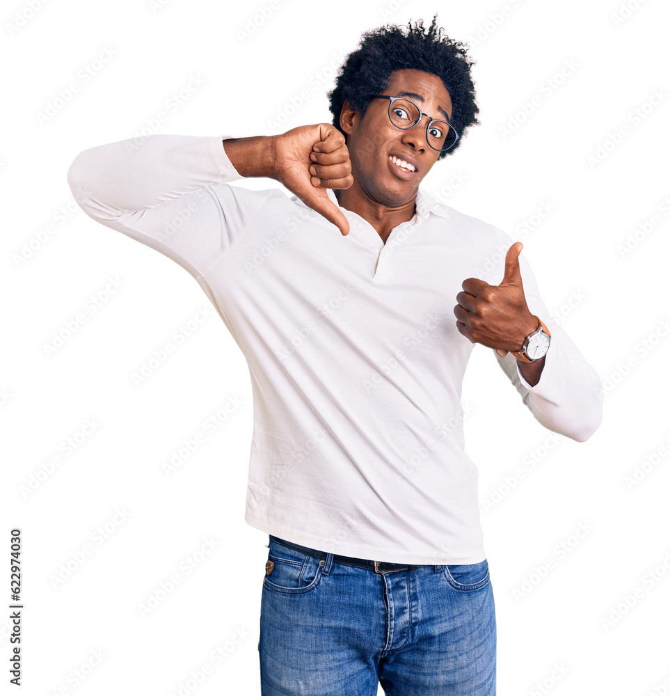 Handsome african american man with afro hair wearing casual clothes and glasses doing thumbs up and down, disagreement and agreement expression. crazy conflict Handsome african american man with afro hair wearing casual clothes and glasses doing thumbs up and down, disagreement and agreement expression. crazy conflict