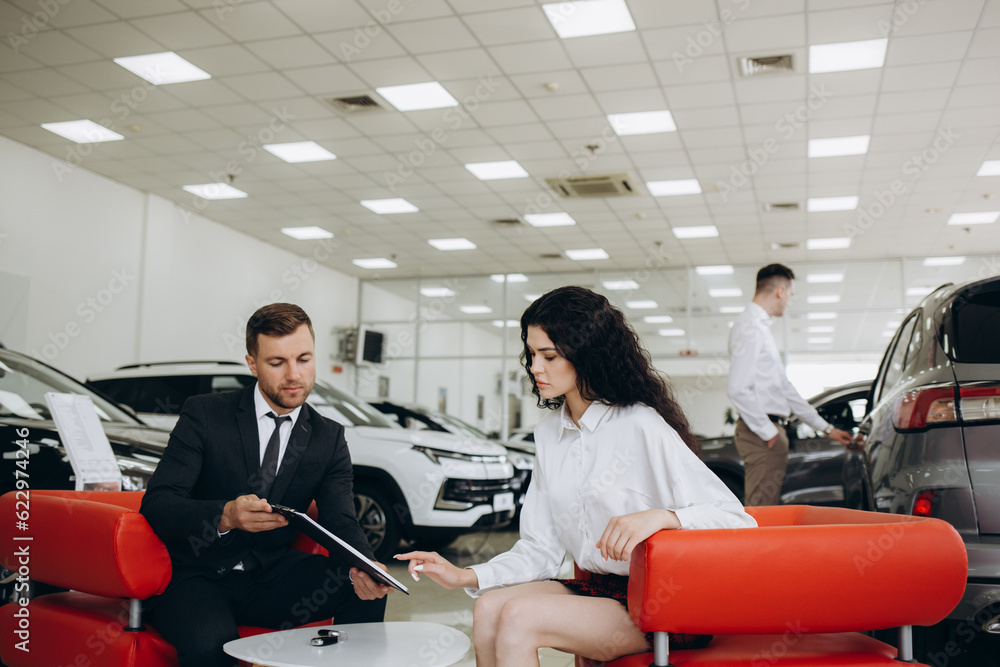 custom made wallpaper toronto digitalMale handsome caucasian shop assistant showing explaining to a female client customer car options information on digital tablet before buying choosing new car auto.
