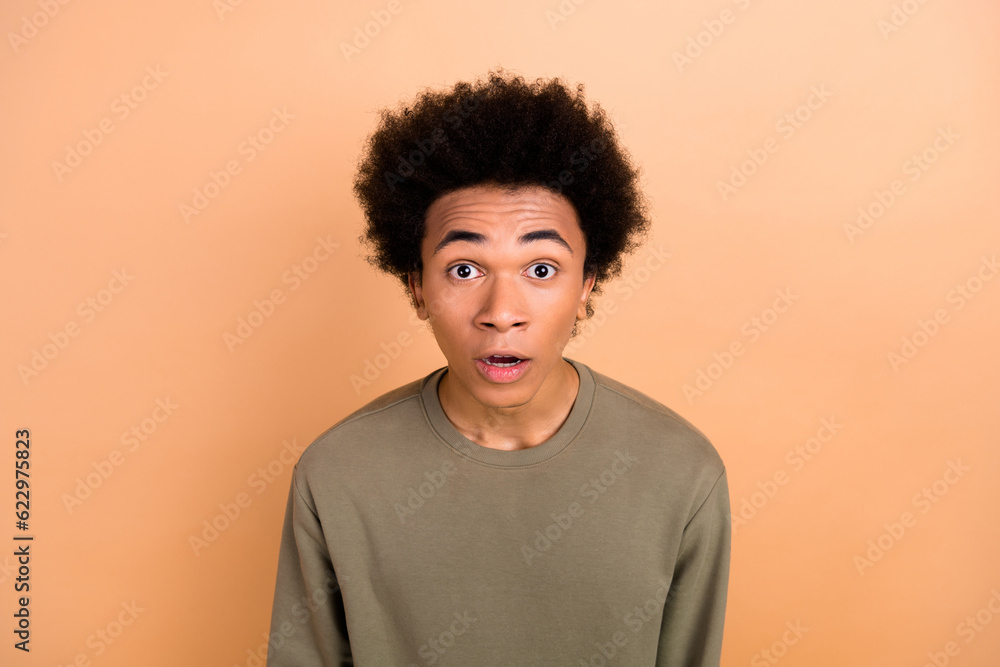 Portrait of impressed speechless young person open mouth staring cant believe isolated on beige color background Portrait of impressed speechless young person open mouth staring cant believe isolated on beige color background