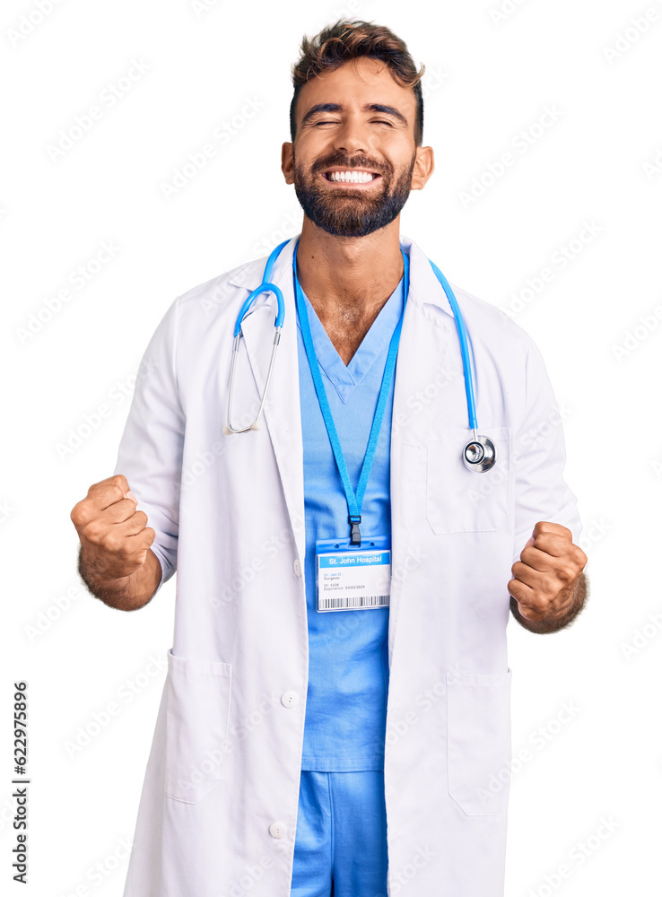 Young hispanic man wearing doctor uniform and stethoscope very happy and excited doing winner gesture with arms raised, smiling and screaming for success. celebration concept. Young hispanic man wearing doctor uniform and stethoscope very happy and excited doing winner gesture with arms raised, smiling and screaming for success. celebration concept.