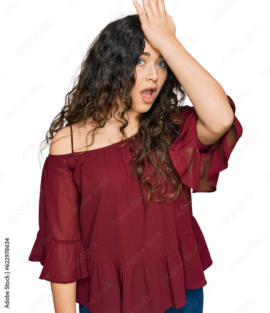 Young hispanic girl wearing casual clothes surprised with hand on head for mistake, remember error. forgot, bad memory concept. Young hispanic girl wearing casual clothes surprised with hand on head for mistake, remember error. forgot, bad memory concept.