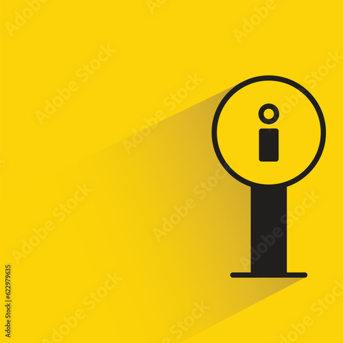 info signage with shadow on yellow background