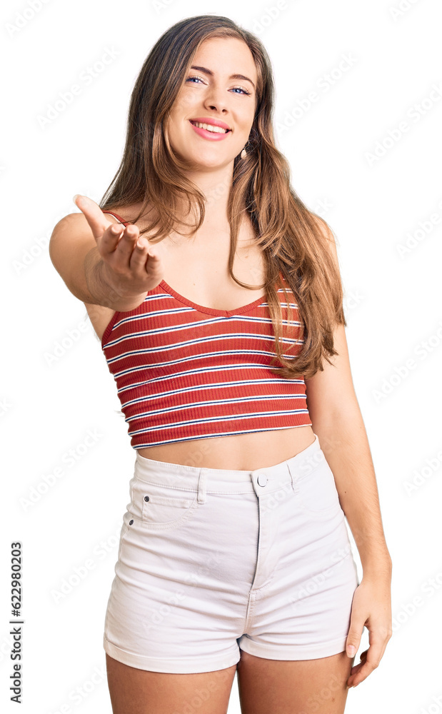 Beautiful caucasian young woman wearing casual clothes smiling friendly offering handshake as greeting and welcoming. successful business. Beautiful caucasian young woman wearing casual clothes smiling friendly offering handshake as greeting and welcoming. successful business.