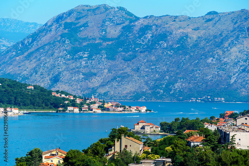 view of the old town of Kotor in Montenegro and the coast of the Bay of Kotor, the sea and medieval European architecture, city streets, red tiled roofs, the concept of traveling across the Balkans