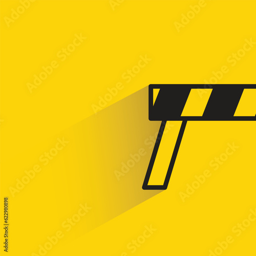 traffic barrier with shadow on yellow background