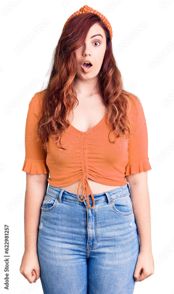 Young beautiful woman wearing casual clothes scared and amazed with open mouth for surprise, disbelief face Young beautiful woman wearing casual clothes scared and amazed with open mouth for surprise, disbelief face
