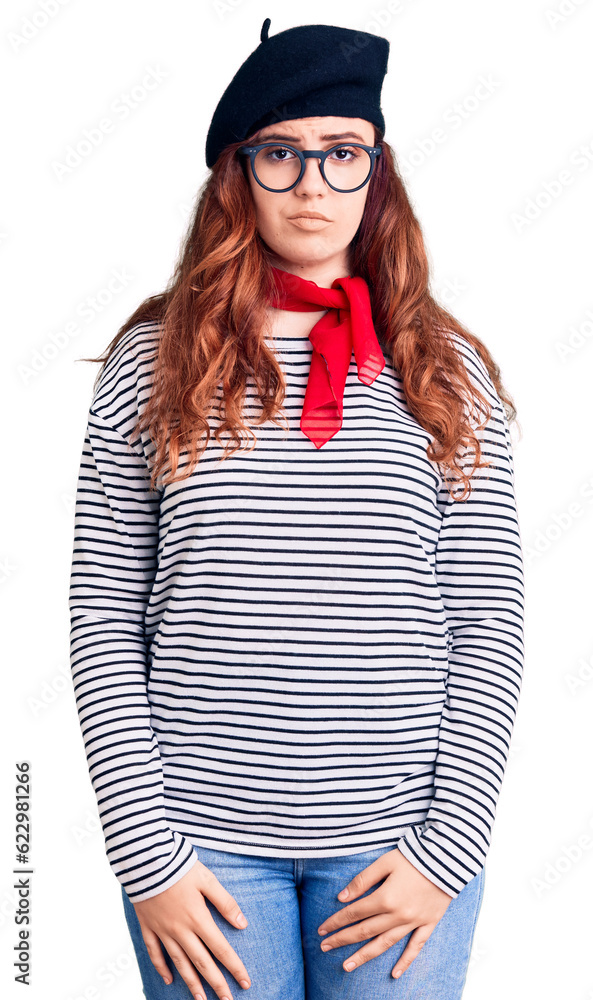 Young beautiful woman wearing french look with beret with serious expression on face. simple and natural looking at the camera. Young beautiful woman wearing french look with beret with serious expression on face. simple and natural looking at the camera.