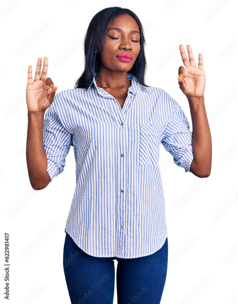 Young african american woman wearing casual clothes relax and smiling with eyes closed doing meditation gesture with fingers. yoga concept. Young african american woman wearing casual clothes relax and smiling with eyes closed doing meditation gesture with fingers. yoga concept.