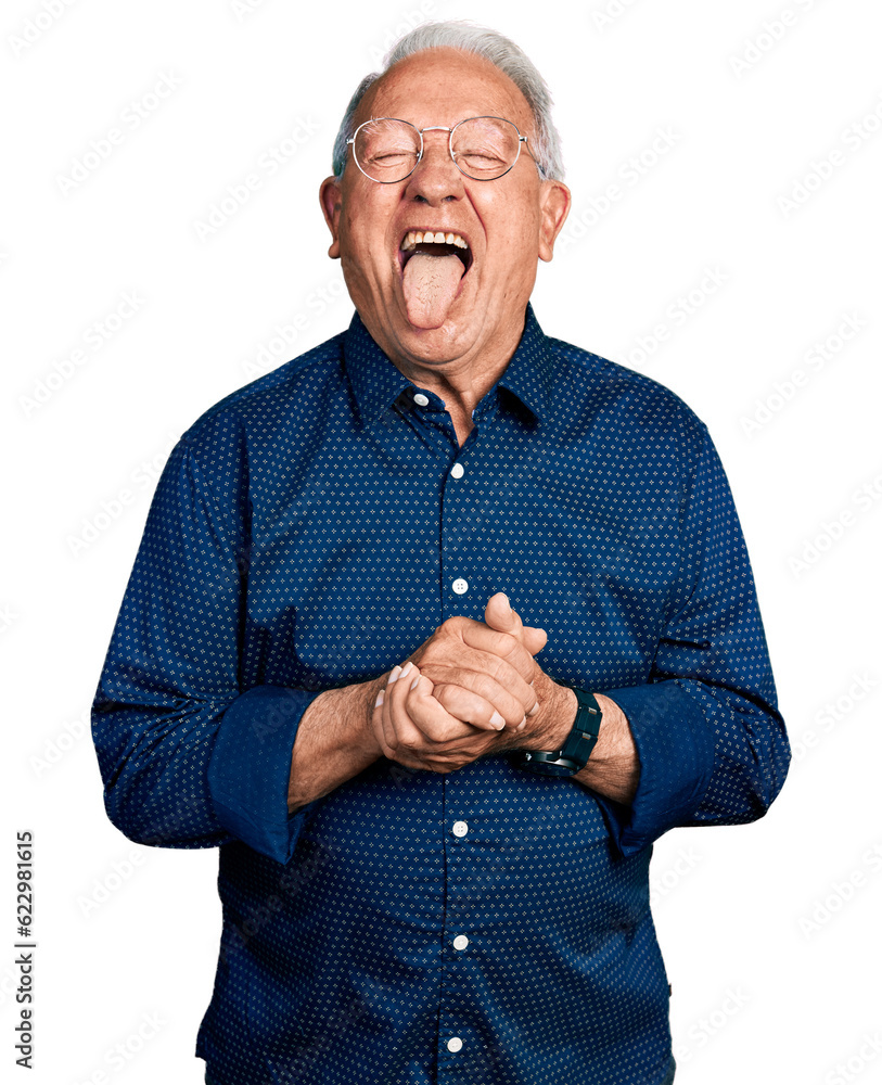 Senior man with grey hair holding hands together sticking tongue out happy with funny expression. Senior man with grey hair holding hands together sticking tongue out happy with funny expression.