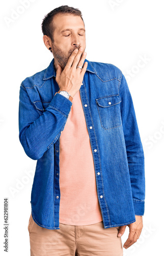 Young handsome man wearing casual clothes bored yawning tired covering mouth with hand. restless and sleepiness.