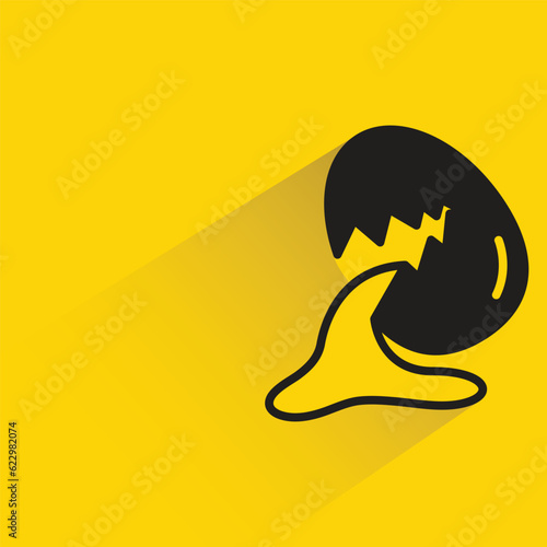 egg with shadow on yellow background