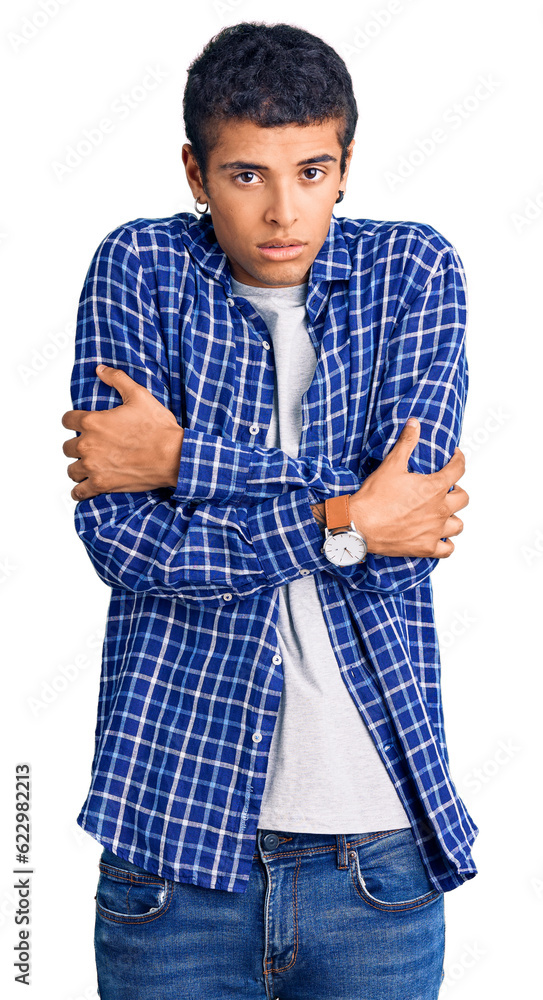 Fototapeta premium Young african amercian man wearing casual clothes shaking and freezing for winter cold with sad and shock expression on face
