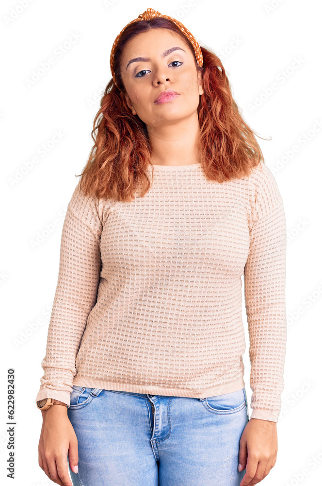 Fototapeta premium Young latin woman wearing casual clothes and diadem relaxed with serious expression on face. simple and natural looking at the camera.