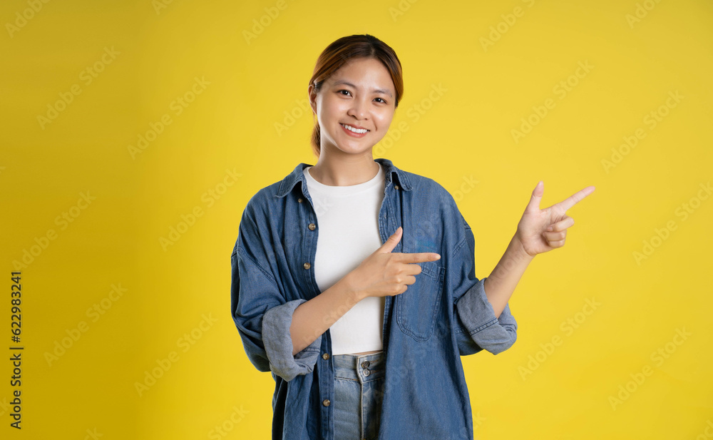 image of asian female students posing on a yellow background image of asian female students posing on a yellow background